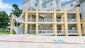 A multi-story building with a fire lane and a handicapped accessible parking space.