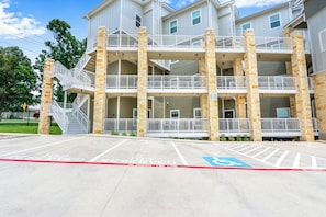 A multi-story building with a fire lane and a handicapped accessible parking space.