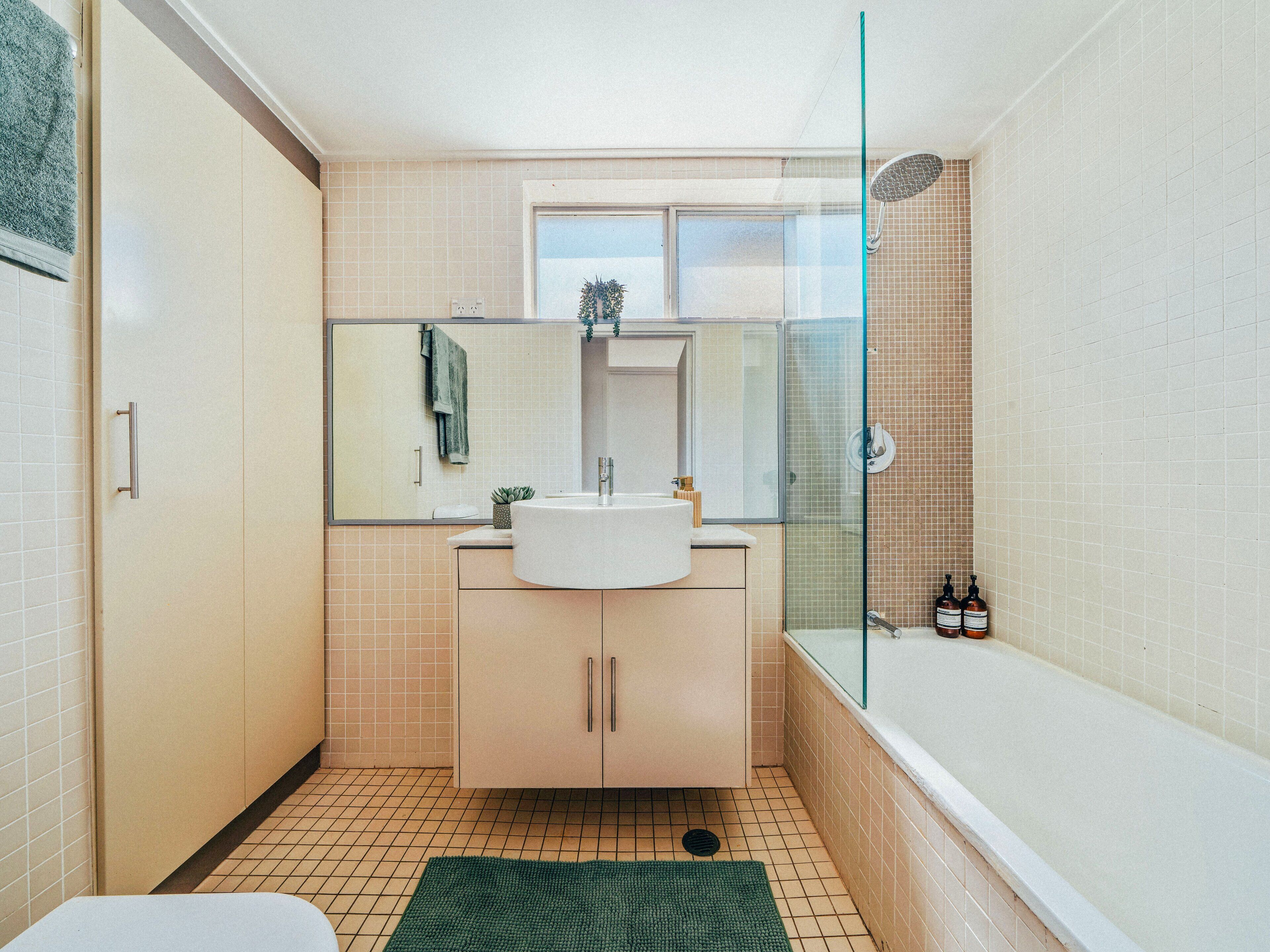 A modern bathroom with a glass shower enclosure, a sink, and a toilet.