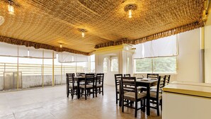 A spacious dining area with high ceilings and natural light from large windows. - The Tiger Heritage  (Sawai Madhopur)