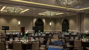 A banquet hall with round tables, chairs, chandeliers, and a carpeted floor. - 2 Connecting Suites at a 4⭐️ Hotel (Arlington)