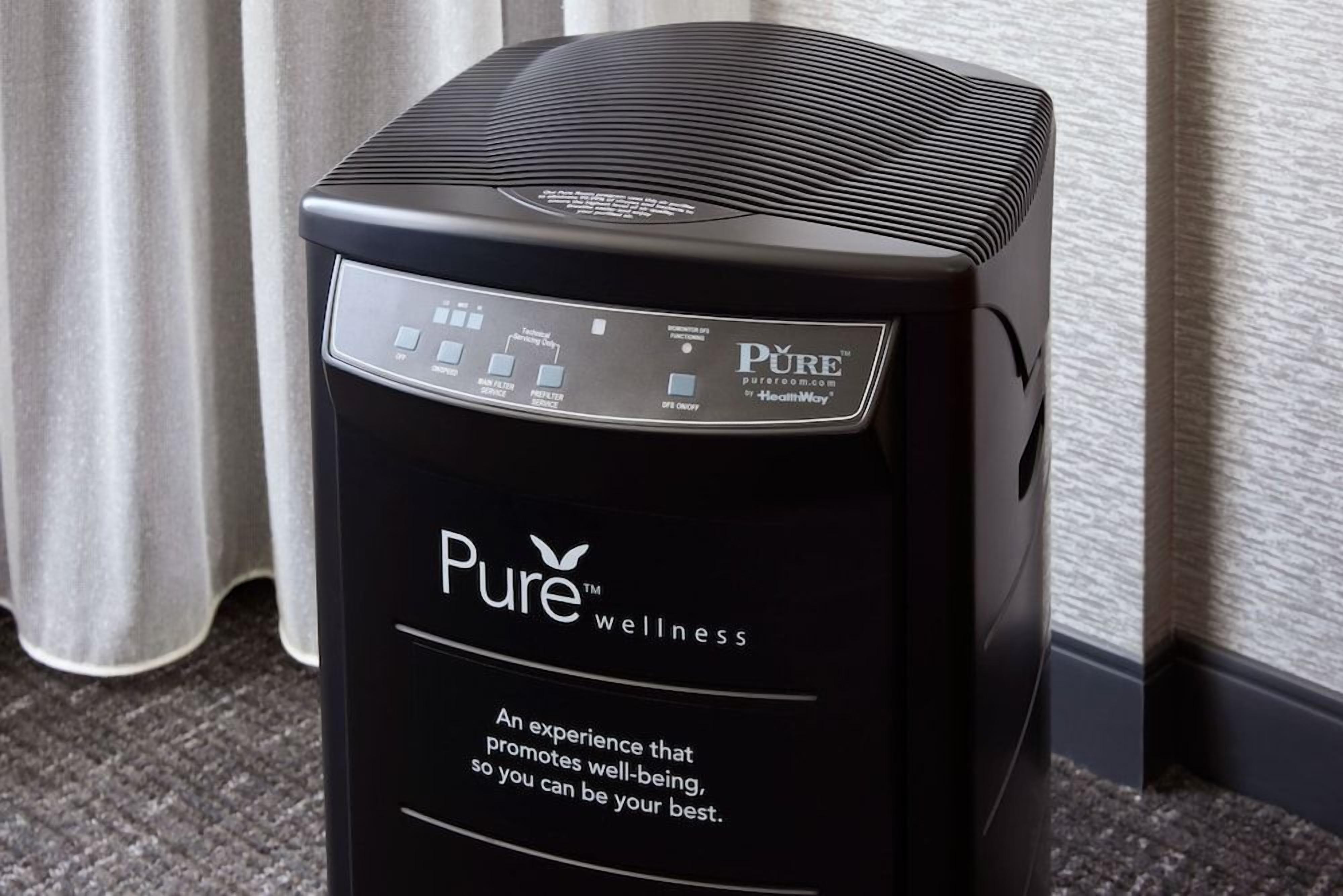 A black wellness machine with control panel and Pure wellness branding.
