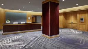 A reception area with a reception desk, a large wooden column, and a carpeted floor. - 2 Connecting Suites at a 4⭐️ Hotel (Arlington)