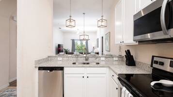 Townhome, Multiple Beds, Balcony, Garden View (Family Ties at Bahama Bay) | Private kitchen | Fridge, microwave, oven, stovetop