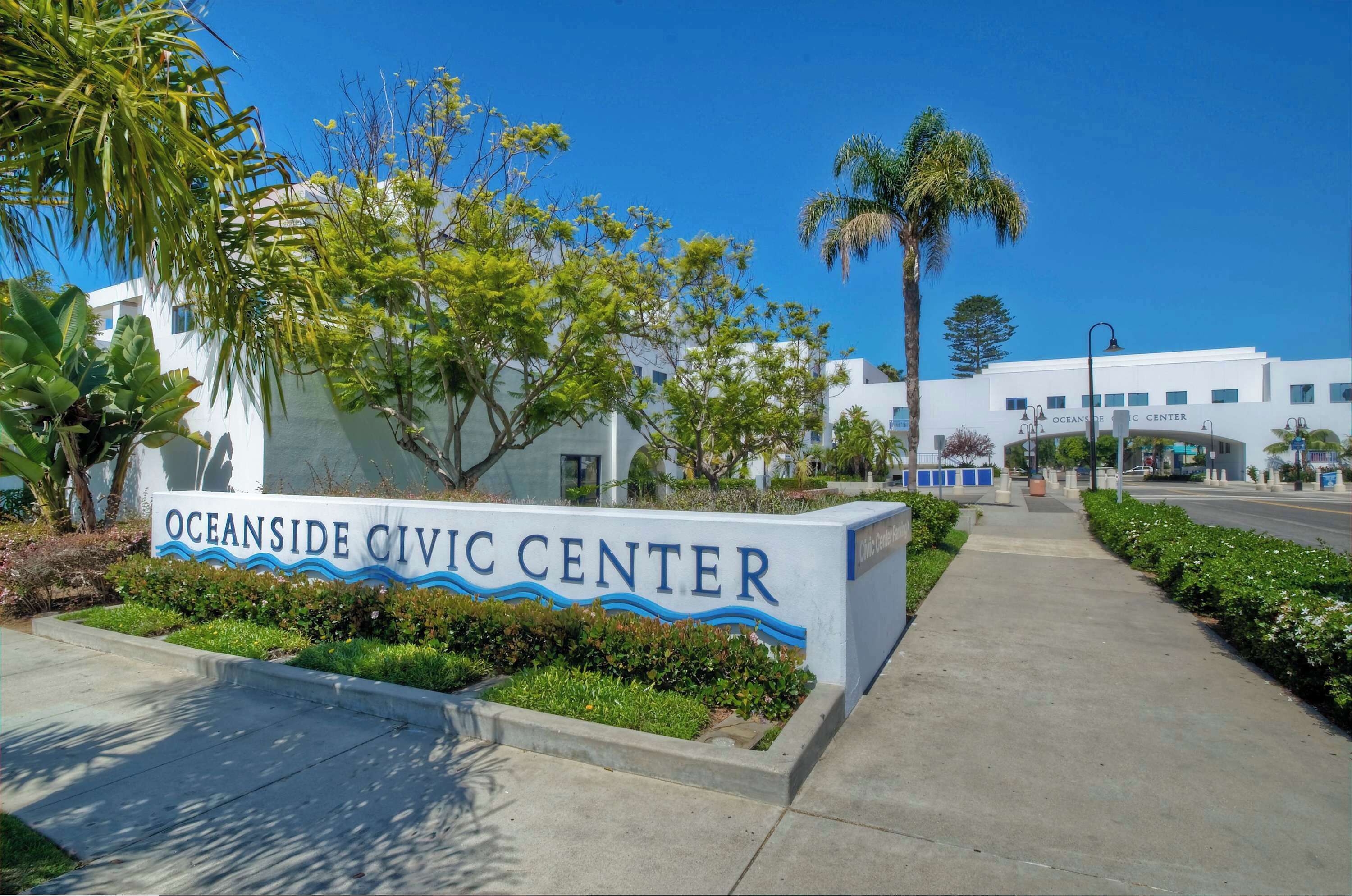 A sign for Oceanside Civic Center with a clear pathway leading to the building.