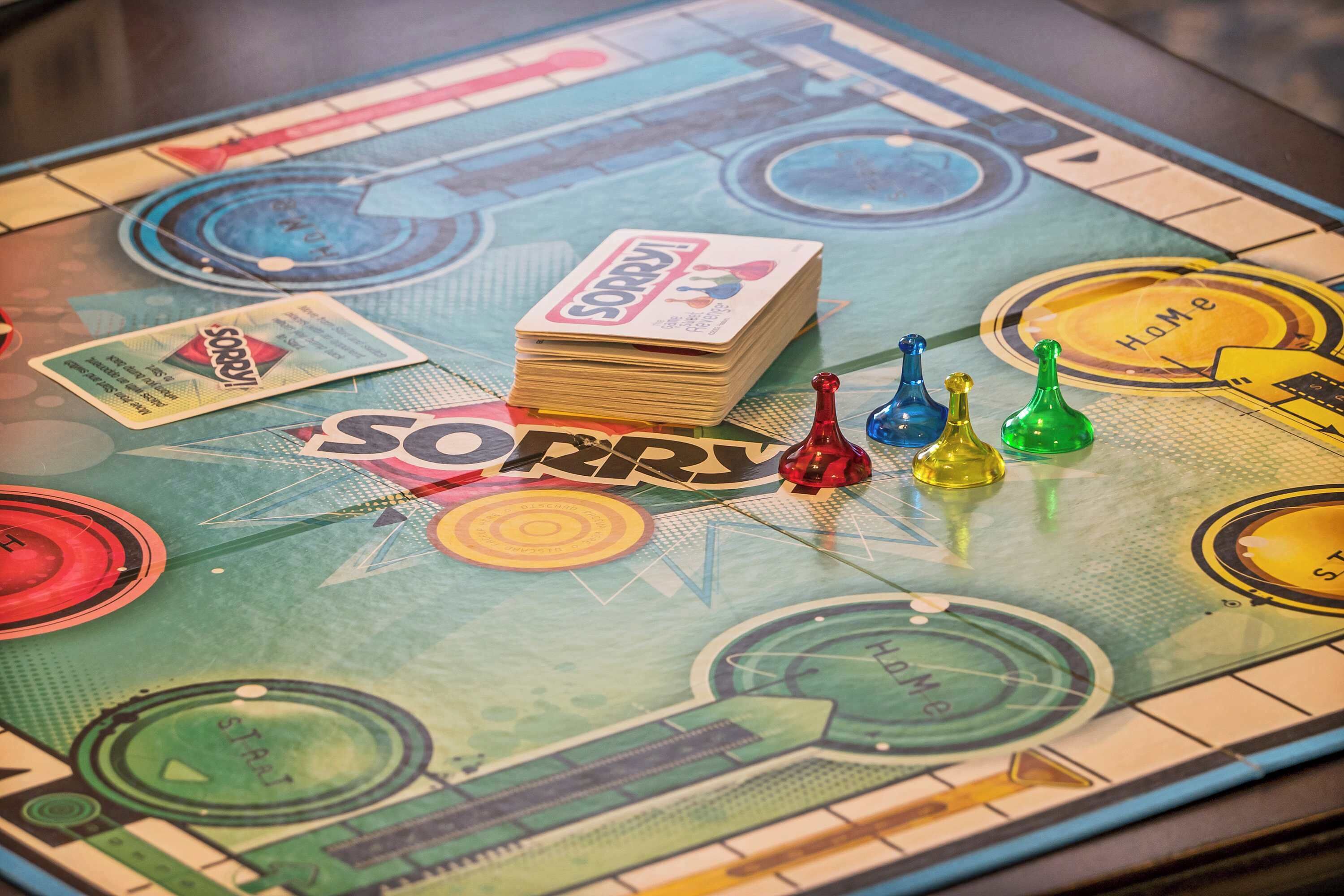 A board game with a 'Sorry!' theme, featuring tokens and cards on a colorful game board.