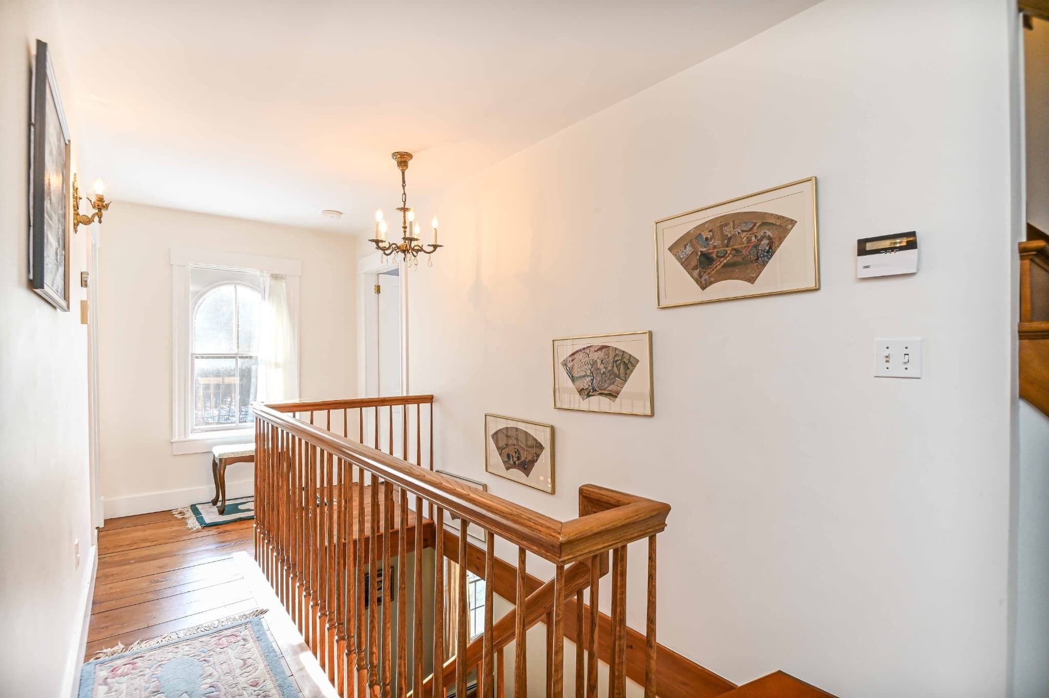 A staircase with wooden railings leading to a landing.