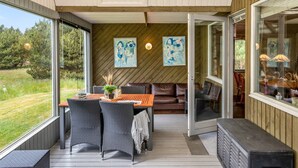 A covered outdoor dining area with a table, chairs, and a bench. - "Tala" - 4km from the sea by Interhome (Blåvand)