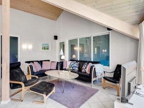 A modern living room with a high ceiling, a sofa set, a coffee table, and a television. - "Femmy" - 600m from the sea by Interhome (Blåvand)