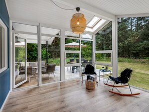 A spacious room with large glass doors leading to an outdoor patio area. - "Eleni" - 2.5km from the sea by Interhome (Blåvand)