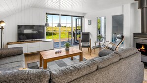 A modern living room with a TV, sofa, and fireplace. - "Joseline" - 1.8km from the sea by Interhome (Blåvand)
