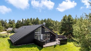 A modern house with a sloped roof, large windows, and a deck. - "Joseline" - 1.8km from the sea by Interhome (Blåvand)