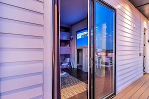 A modern interior with a sliding glass door leading to a living area.