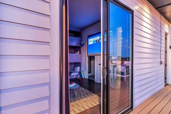 A modern interior with a sliding glass door leading to a living area.