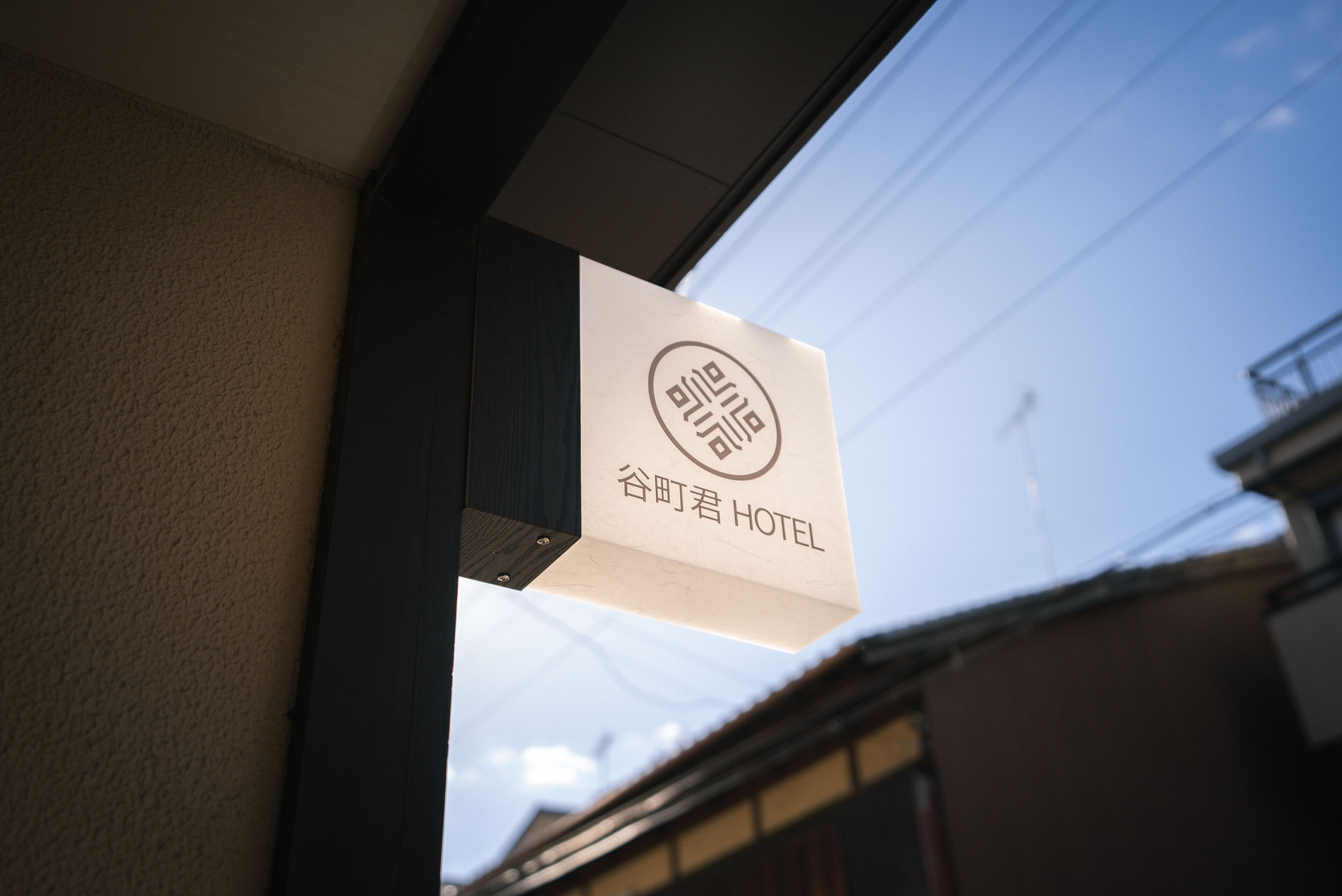 Ein Hotel-Schild mit dem Schriftzug "谷町君 HOTEL" in japanischer Schrift.