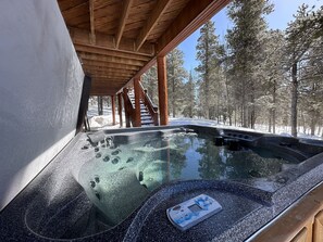 A hot tub under a wooden gazebo with a snowy forest backdrop. - Lovely 3BR Near Town w/ Hot Tub, Stunning Views! (Fairplay)