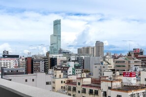 A cityscape with a prominent skyscraper, various mid-rise buildings, and signage in a foreign language. - Tanimachikun Star Hotel Ebisunishi 48 (Osaka)