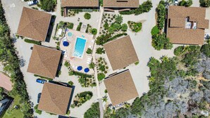 An aerial view of a residential area with multiple houses, a swimming pool, and a small garden area. - Pet friendly paradise on Sanibel Island with private beach - Signal Inn 12 (Sanibel)