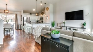 A modern kitchen with white cabinets, stainless steel appliances, and pendant lighting. - Spokane Valley Home w/ Fire Pit - 1 Mi to Trails! (Spokane Valley)