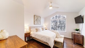 A bedroom with a bed, bedside tables, a window, a ceiling fan, and a TV. - Spokane Valley Home w/ Fire Pit - 1 Mi to Trails! (Spokane Valley)
