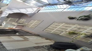A tiled patio area with a grill, potted plants, and a patterned rug. - Hotel O Cprc Inn Serpong (Cisauk)