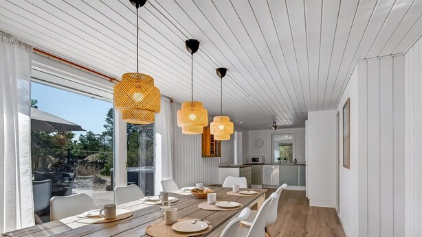 A modern dining area with a wooden table, white chairs, and woven pendant lights. - "Allen" - 1km from the sea by Interhome (Blåvand)
