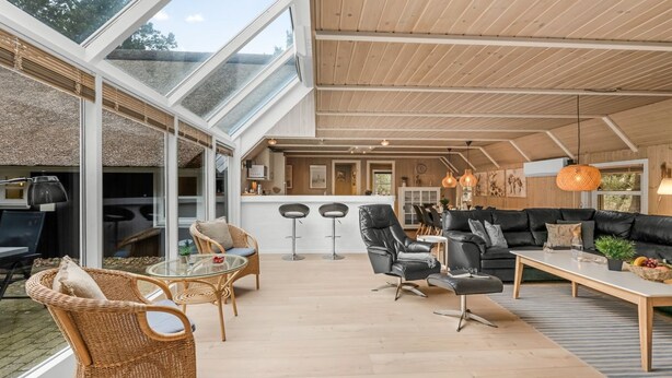 A spacious indoor area with a high ceiling, a dining area, and a seating area with a sofa and chairs. - "Verna" - 800m from the sea by Interhome (Blåvand)