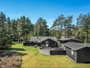 A lodge with multiple cabins, a central building with a porch, and a well-maintained lawn.