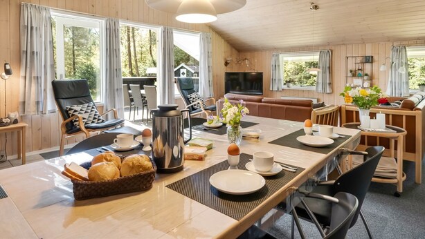 A spacious cabin interior with a dining area, seating, and a TV. - "Valpuri" - 1.3km to the fjord by Interhome (Blåvand)