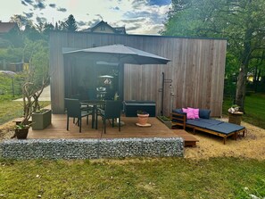 A patio with a table and chairs, a sofa, and a covered seating area. - Holiday Home 'Schmidtsches Quartier' with Mountain View, Private Terrace and Wi-Fi (Oybin)
