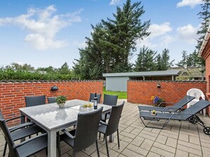 A patio with a table and chairs, a grill, and a lounge area with chairs. - "Pernilla" - 2km from the sea by Interhome (Blåvand)