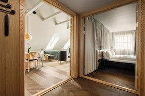 A modern interior with a loft-style bedroom, a dining area, and a living space. - Skostredet Hotel & Spa (Bergen)