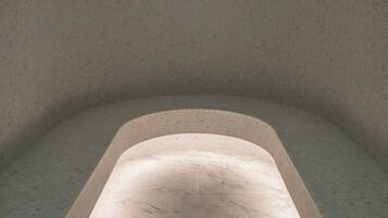 A spa room with a curved seating area and a marble floor.