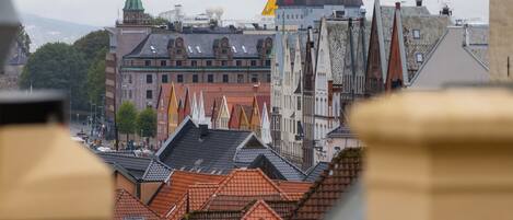 A cityscape with traditional architecture, including buildings with steep roofs and pointed gables.