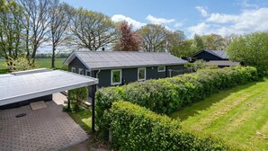 A residential area with a house featuring a sloped roof, a paved driveway, and a well-maintained lawn. - "Francis" - 300m from the sea by Interhome (Rødvig Stevns)