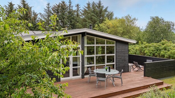 A modern house with a deck, large windows, and outdoor furniture. - "Akkar" - 1.8km from the sea by Interhome (Blåvand)