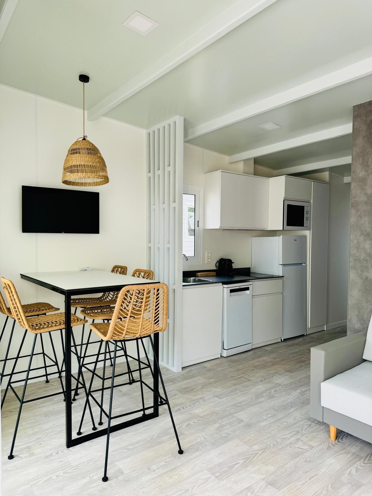 A modern kitchen with white cabinets, a built-in microwave, and a dishwasher.