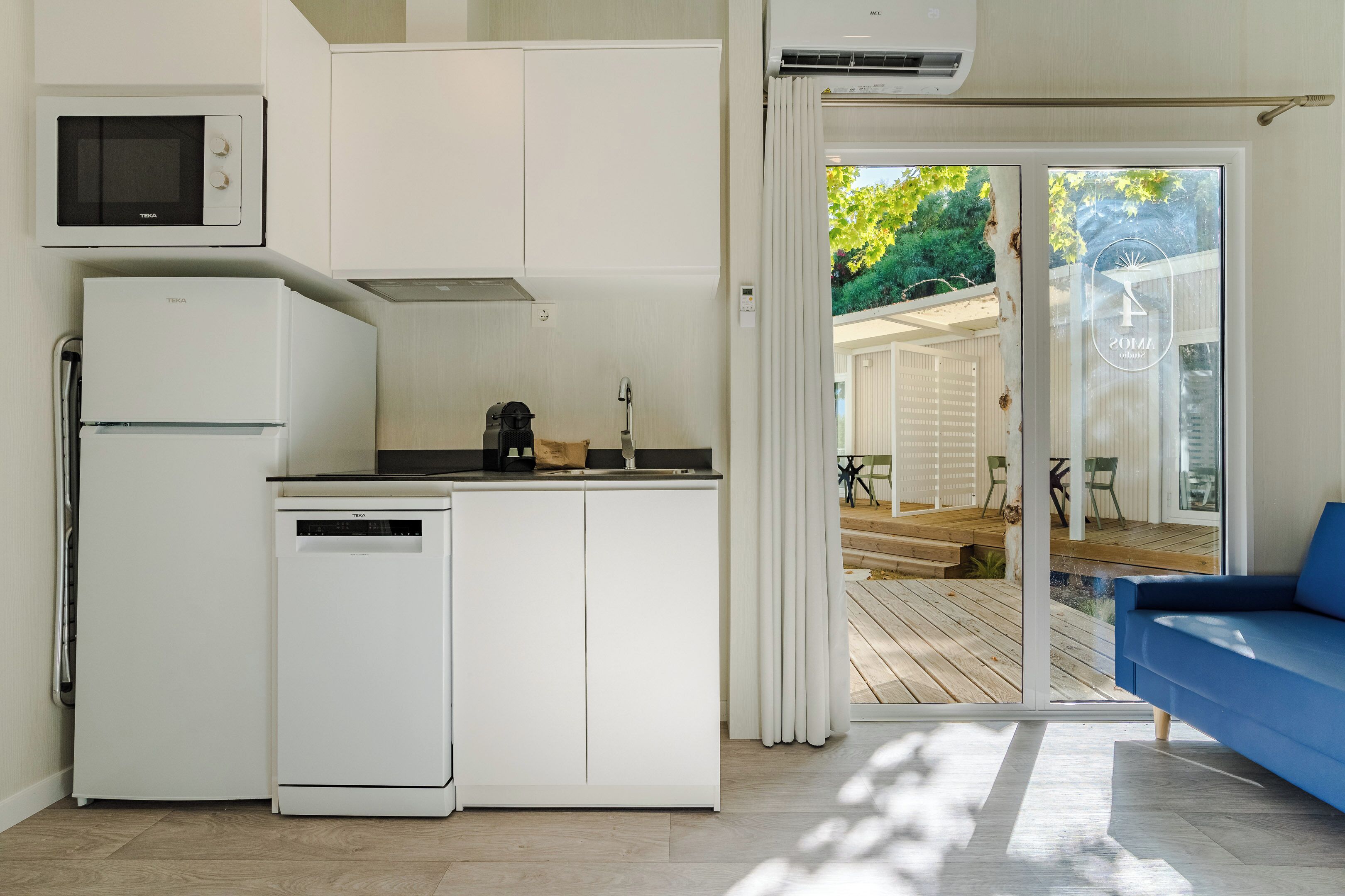 A compact kitchen with a microwave, refrigerator, and dishwasher.