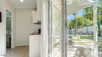 A modern kitchen with a sliding glass door leading to an outdoor patio area.