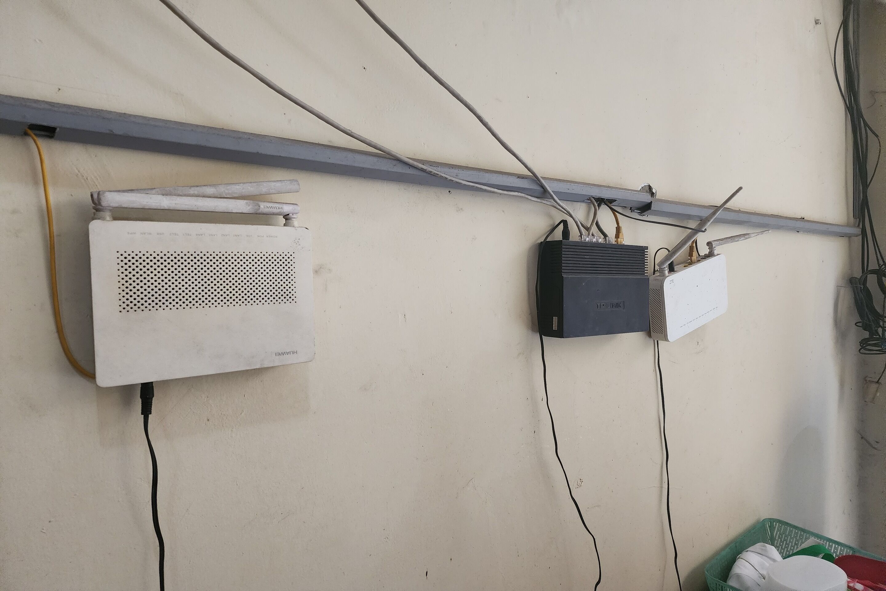 Two air conditioning units mounted on a wall with visible wiring.