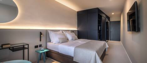 A modern bedroom with a large bed, bedside tables, a wardrobe, and a mirror.