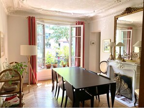 Enjoy a classic dining experience near a window with a fireplace and traditional decor.