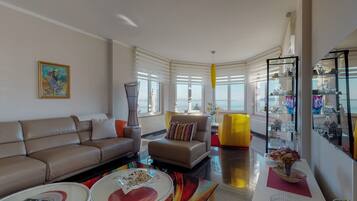 Superior Apartment | Living area | 90-cm LCD TV with satellite channels