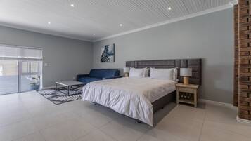 Deluxe Apartment, Pool View | Desk, iron/ironing board (on request), WiFi (free), bed sheets