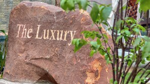 A large rock with the inscription "The Luxury" on it. - The Luxury (Siem Reap)