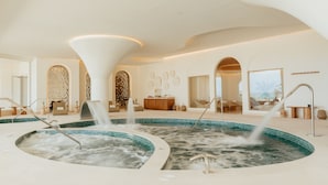 A spa area with multiple hot tubs and a large arched doorway.