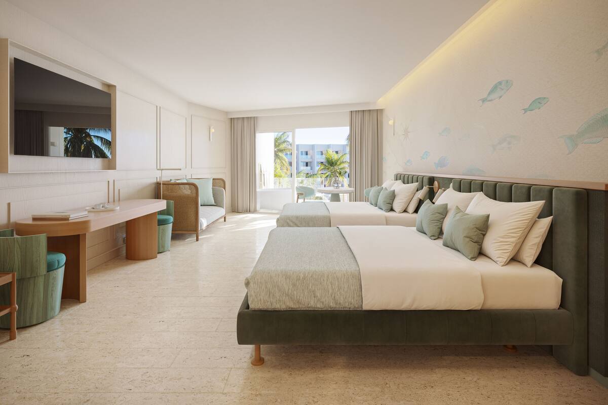Et hotelværelse med en stor seng, et skrivebord, en stol og et fjernsyn.