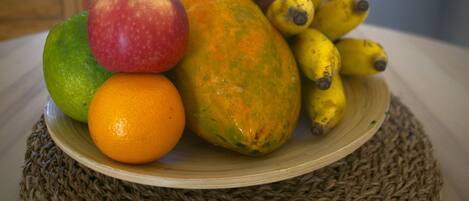 A plate of fruits including apples, oranges, and bananas.