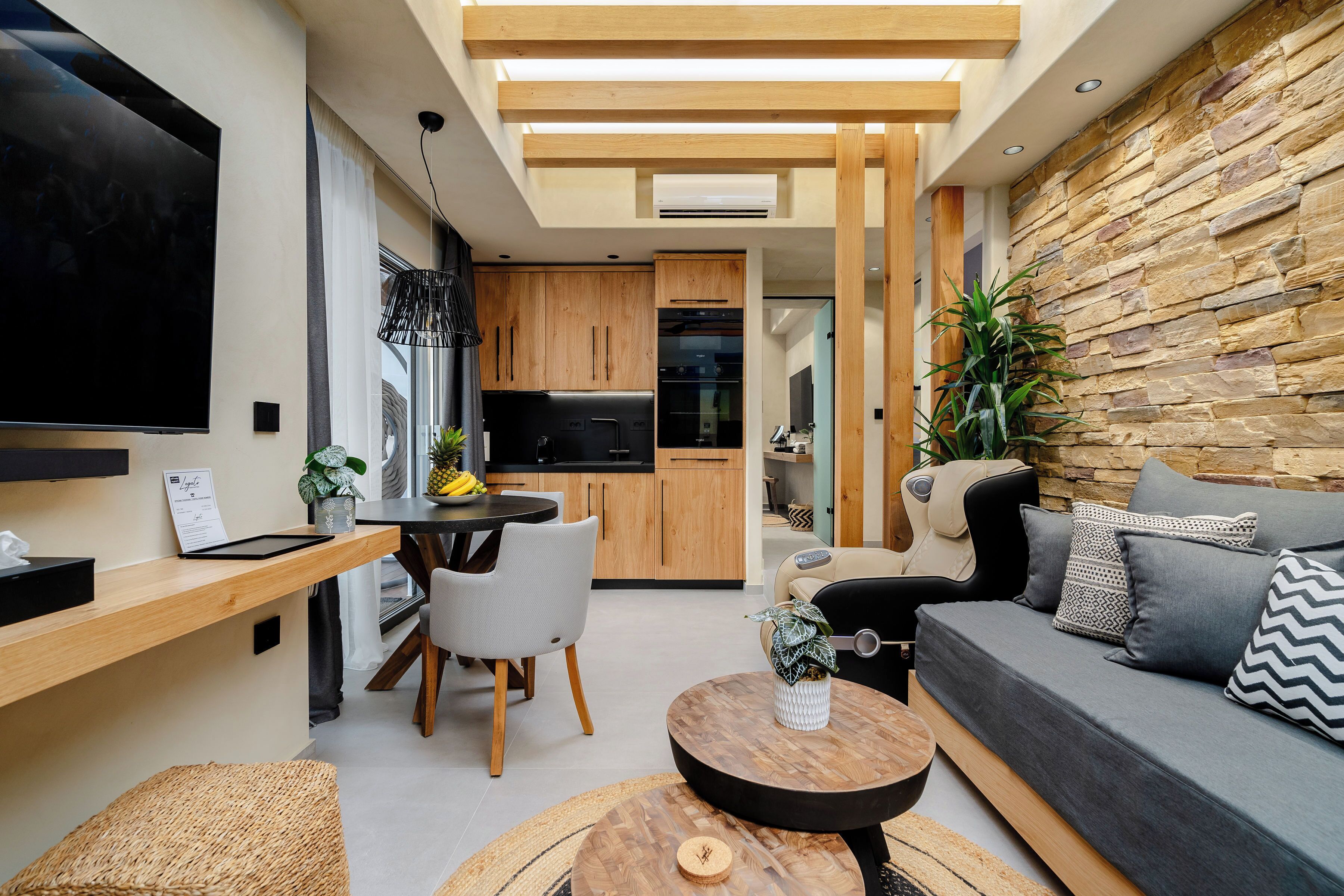 A modern living space with a kitchen, dining area, and seating area.