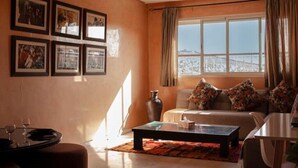 A living room with a sofa, coffee table, and framed pictures on the wall.